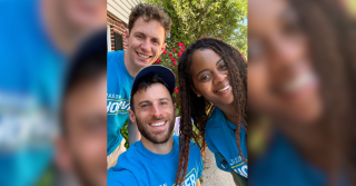 Jason Hoover and four volunteers in blue campaign shirts take a selfie outdoors before a lit drop in District 4, Wilmington.