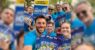 Jason Hoover and four volunteers in blue campaign shirts take a selfie outdoors before a lit drop in District 4, Wilmington.