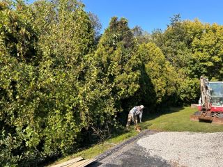 Marking out lines before excavation and grading work for natural stone boulder wall installation in West Chester, PA