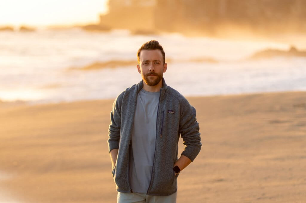 Portrait of photographer Taylor Mickal on a beach